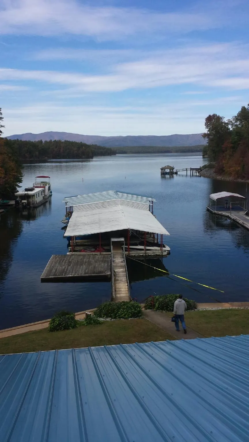 View across a lake from a newly installed blue metal roof in Mansfield